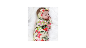 Floral jersey knit swaddle and matching headband. Stretchy jersey knit + cotton blend makes this the perfect swaddle for baby.