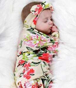 Floral jersey knit swaddle and matching headband. Stretchy jersey knit + cotton blend makes this the perfect swaddle for baby.