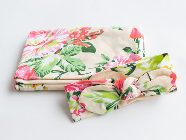 Floral jersey knit swaddle and matching headband. Stretchy jersey knit + cotton blend makes this the perfect swaddle for baby.